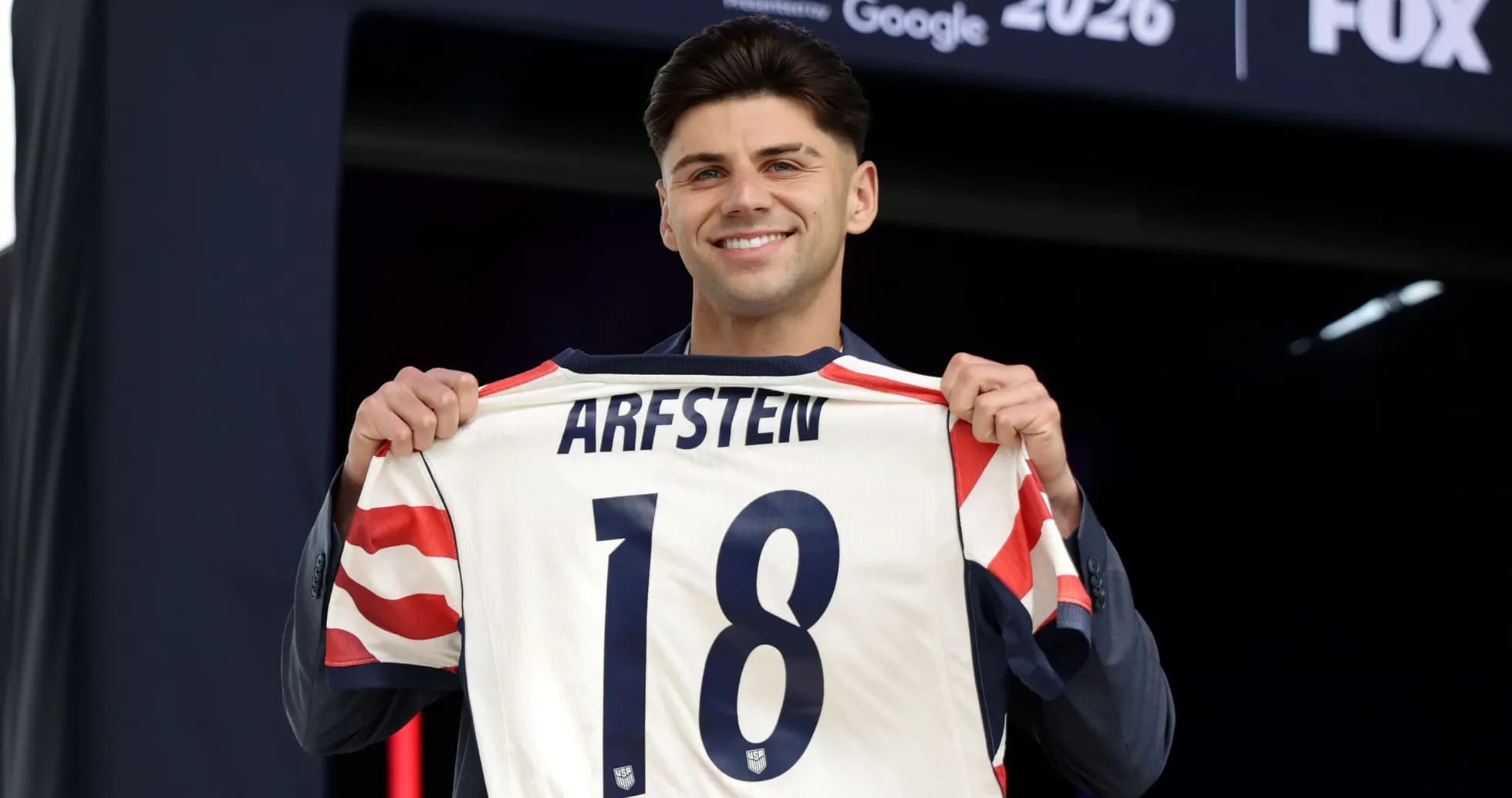 Futbolchi ARFSTEN 18 raqamli formani ko'rsatmoqda Futbolchi ARFSTEN 18 raqamli formani ko'rsatmoqda