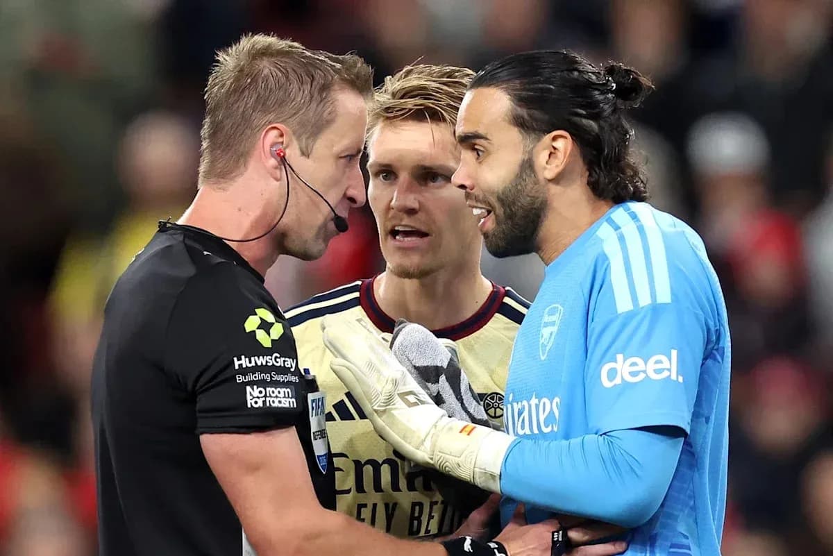 Goalkeeper and players discussing with referee on field Goalkeeper and players discussing with referee on field