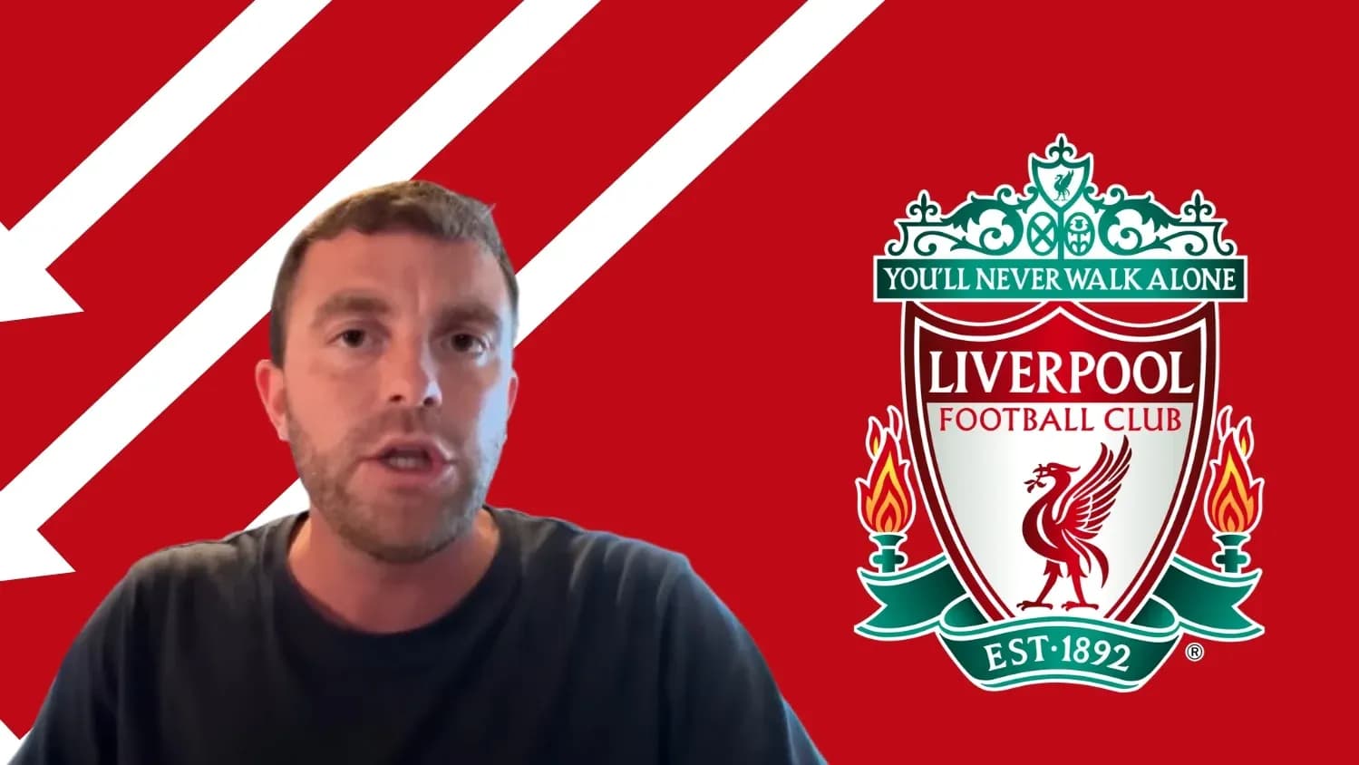 Man speaking in front of Liverpool FC logo Man speaking in front of Liverpool FC logo