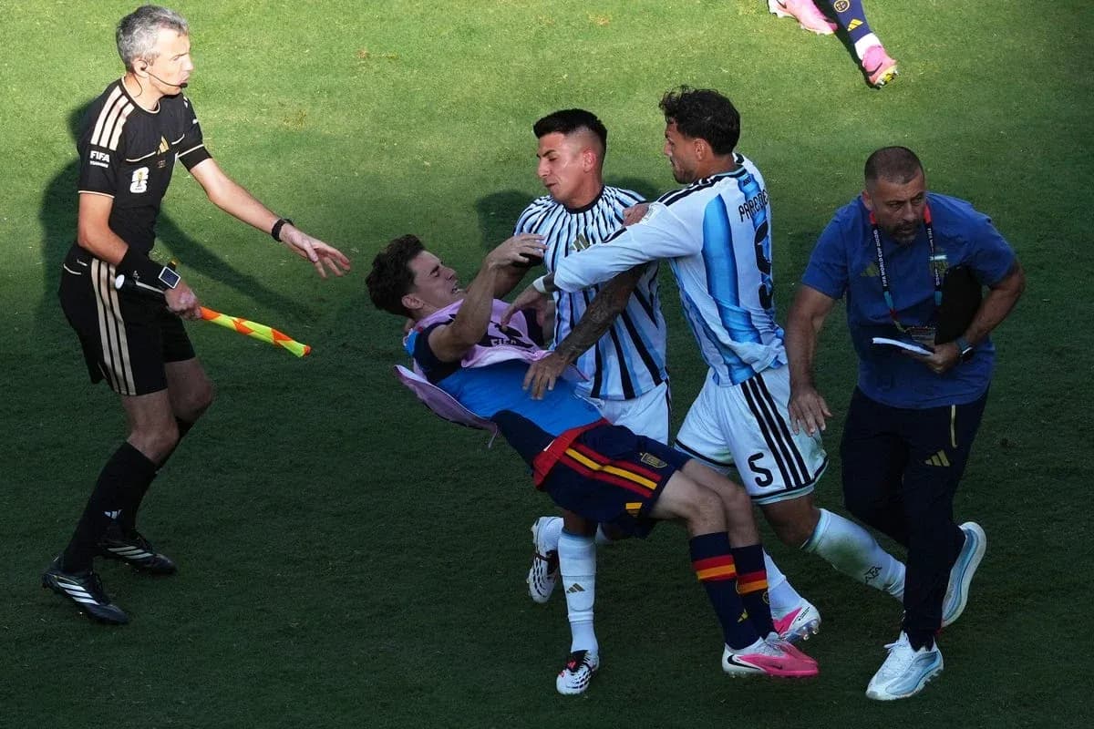 Players clashing on the field during a match Players clashing on the field during a match