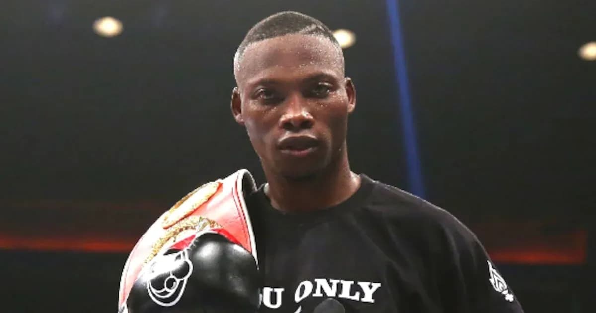 Boxer holding championship belt in ring Boxer holding championship belt in ring
