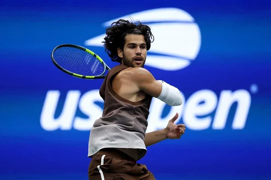Tennis player hitting backhand during US Open match Tennis player hitting backhand during US Open match