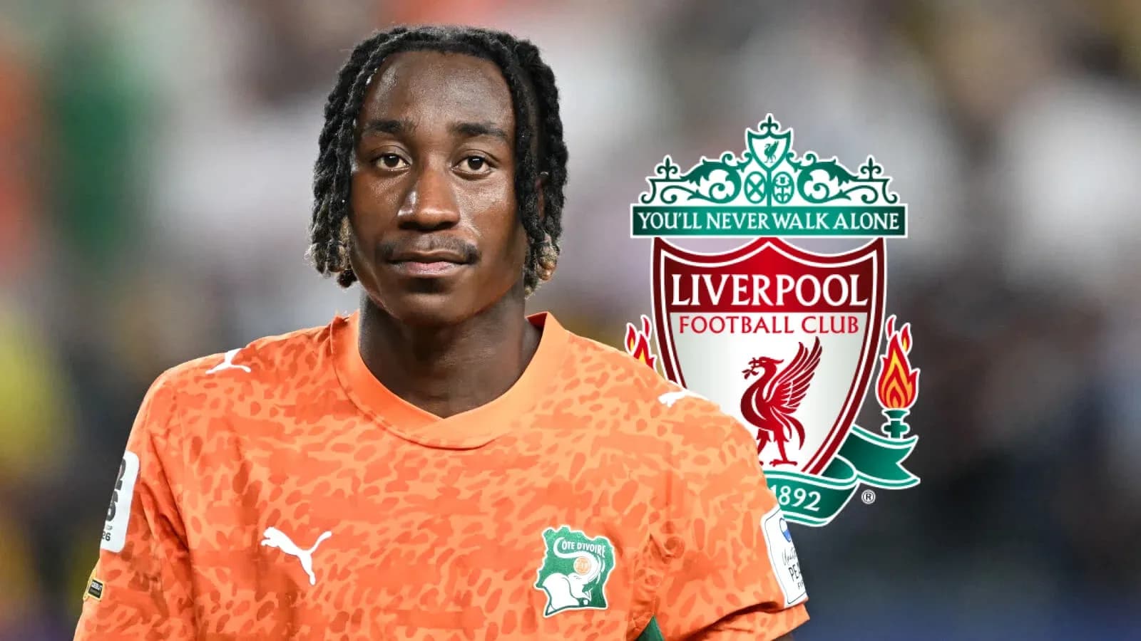 Goalkeeper in orange kit with Liverpool logo background Goalkeeper in orange kit with Liverpool logo background