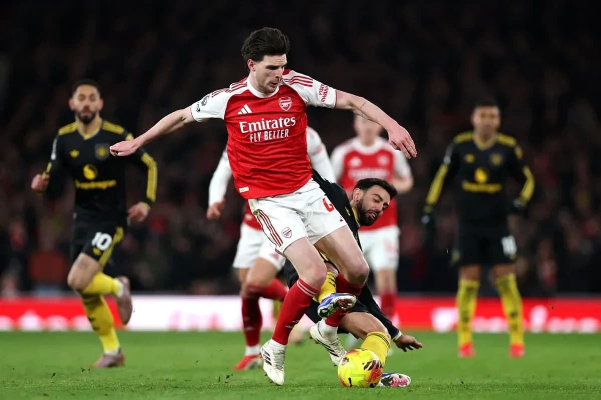 Arsenal player challenging opponent for the ball Arsenal player challenging opponent for the ball