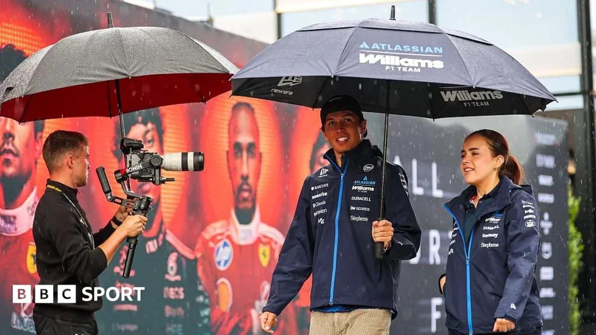 F1 drivers under umbrellas during rainy event F1 drivers under umbrellas during rainy event