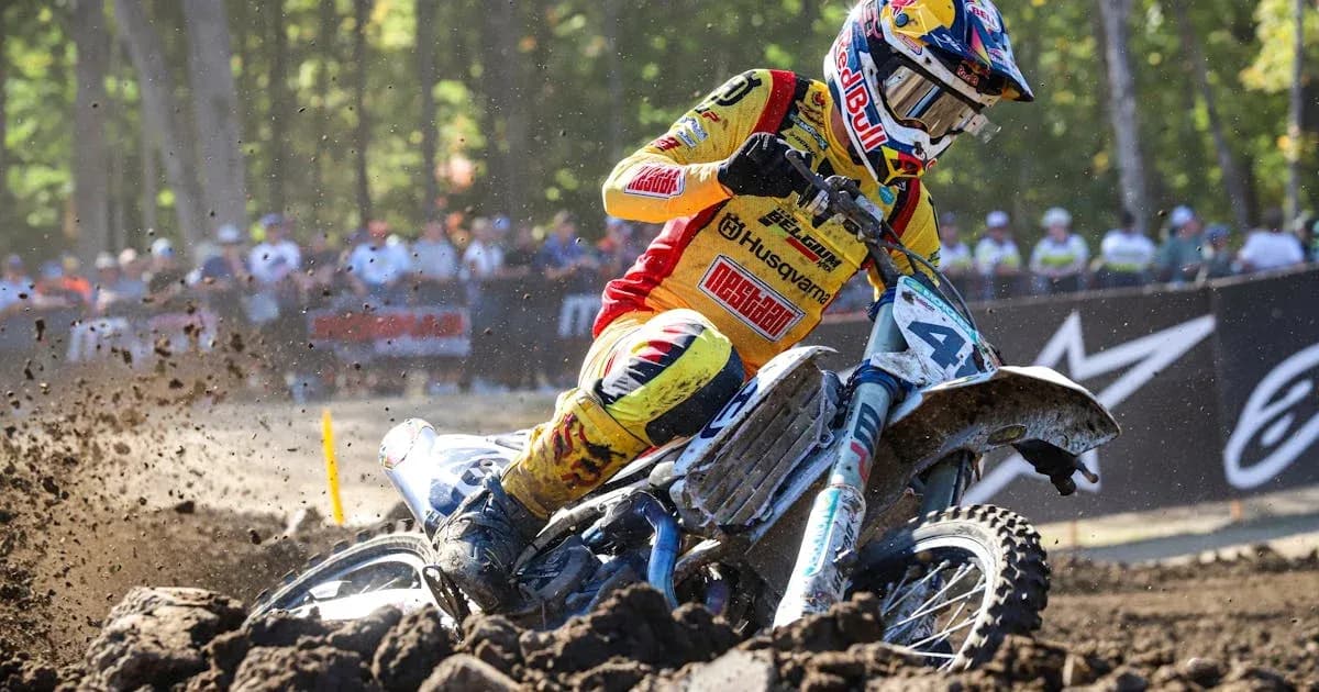 Motocross racer navigating through muddy terrain Motocross racer navigating through muddy terrain