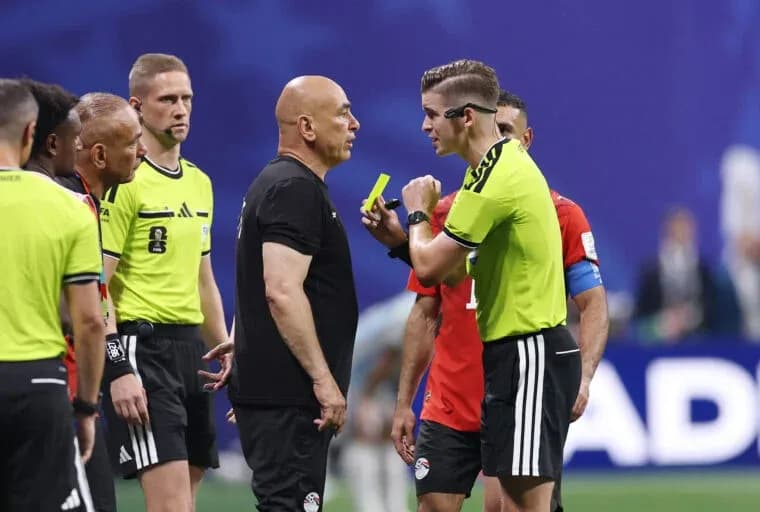 Referees discussing with team officials during match Referees discussing with team officials during match