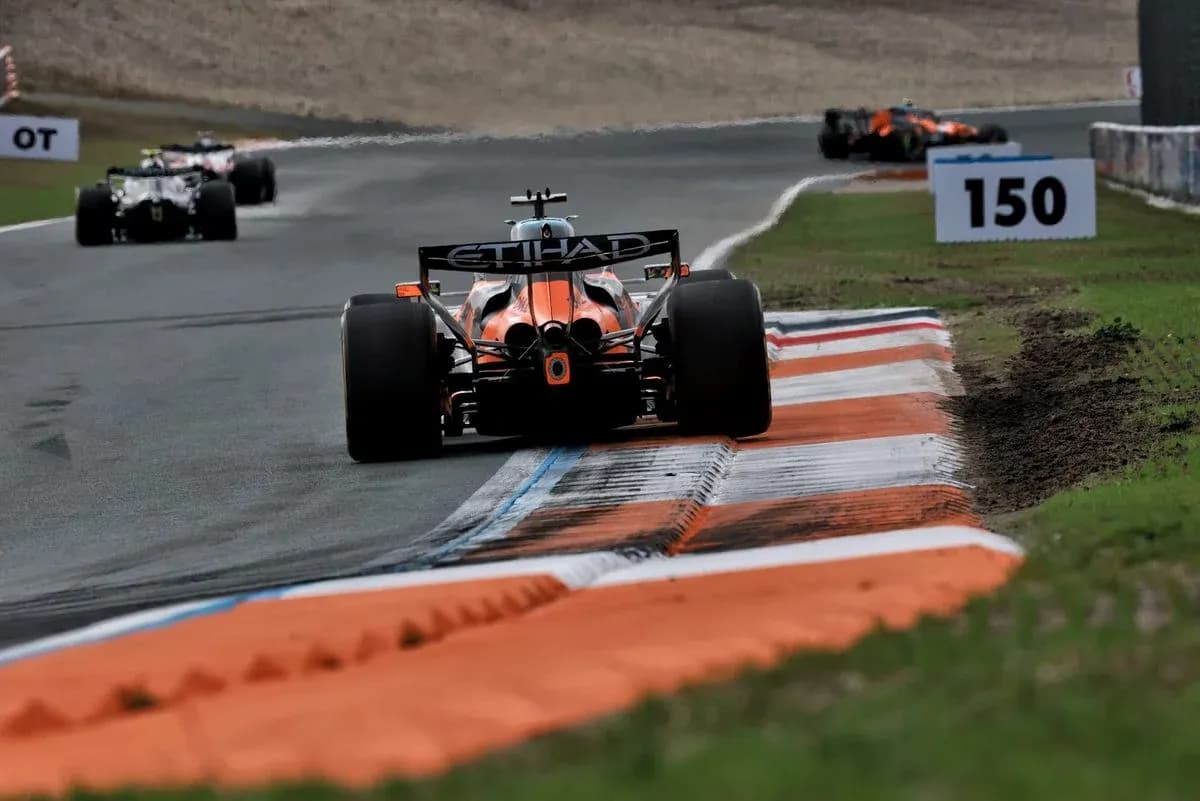 Formula 1 car navigating a corner on track Formula 1 car navigating a corner on track