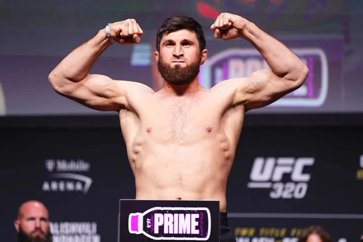 Fighter weighing in with arms flexed at UFC event Fighter weighing in with arms flexed at UFC event