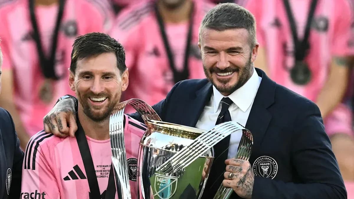 Messi and Beckham celebrating with trophy after match Messi and Beckham celebrating with trophy after match