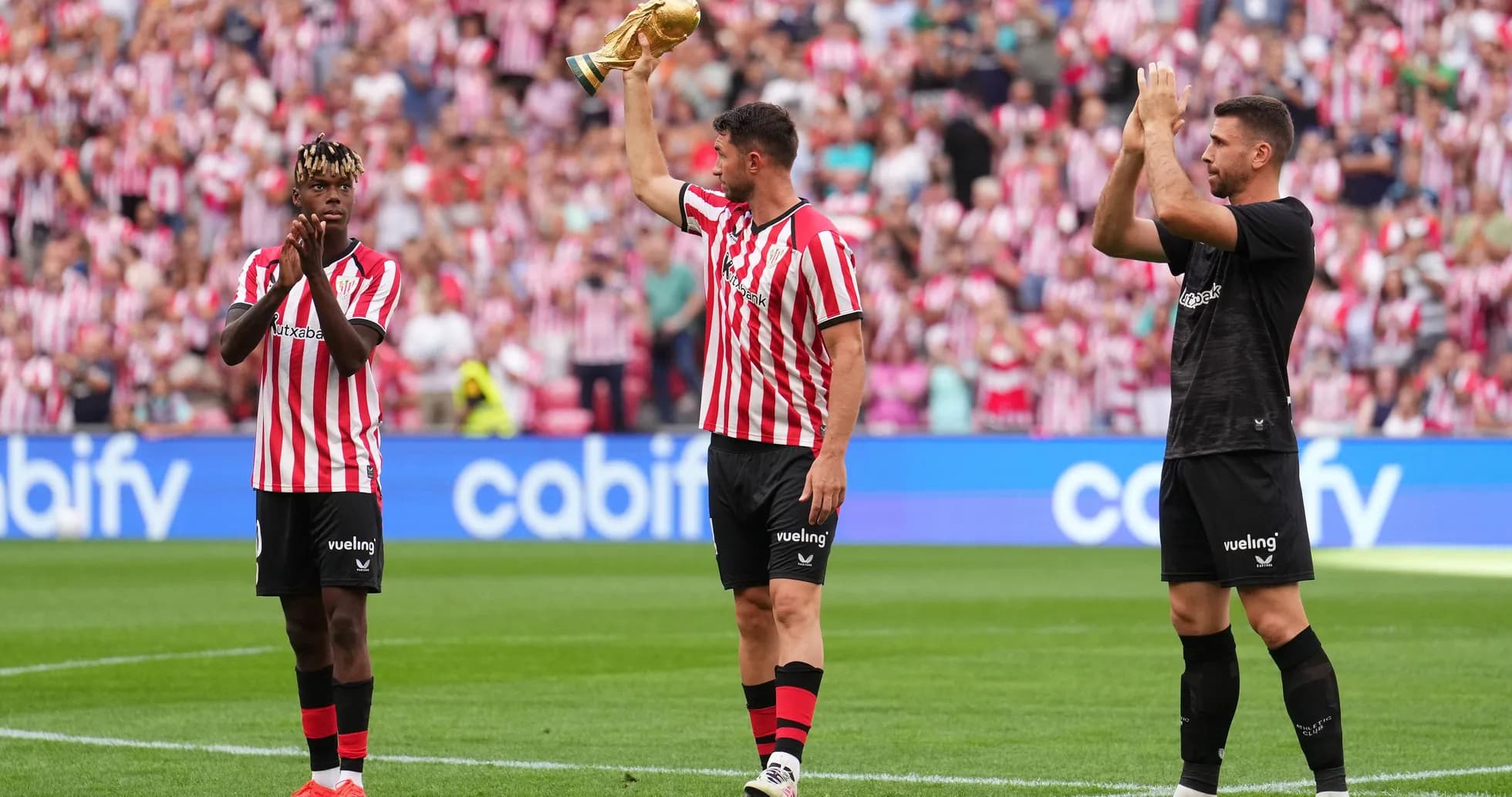Athletic Bilbao players celebrating with trophy at stadium Athletic Bilbao players celebrating with trophy at stadium