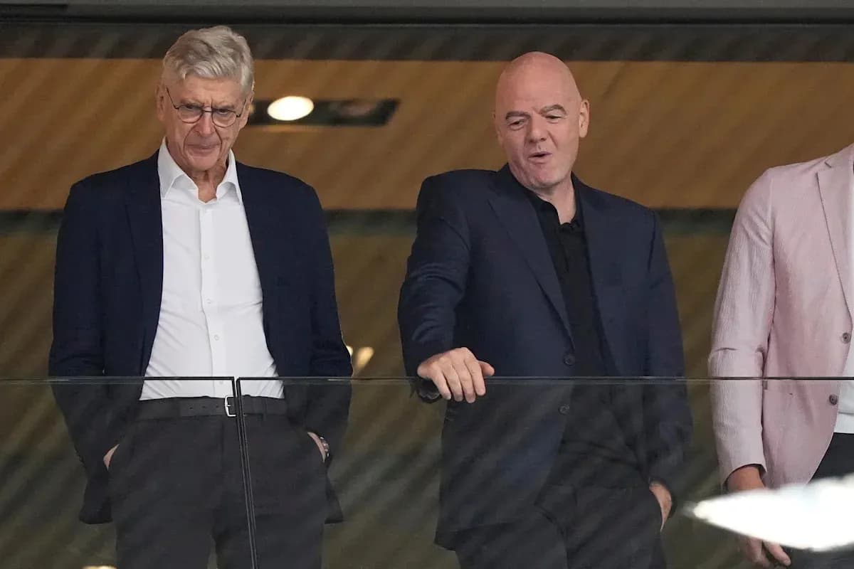 Two men in suits observing an event together Two men in suits observing an event together