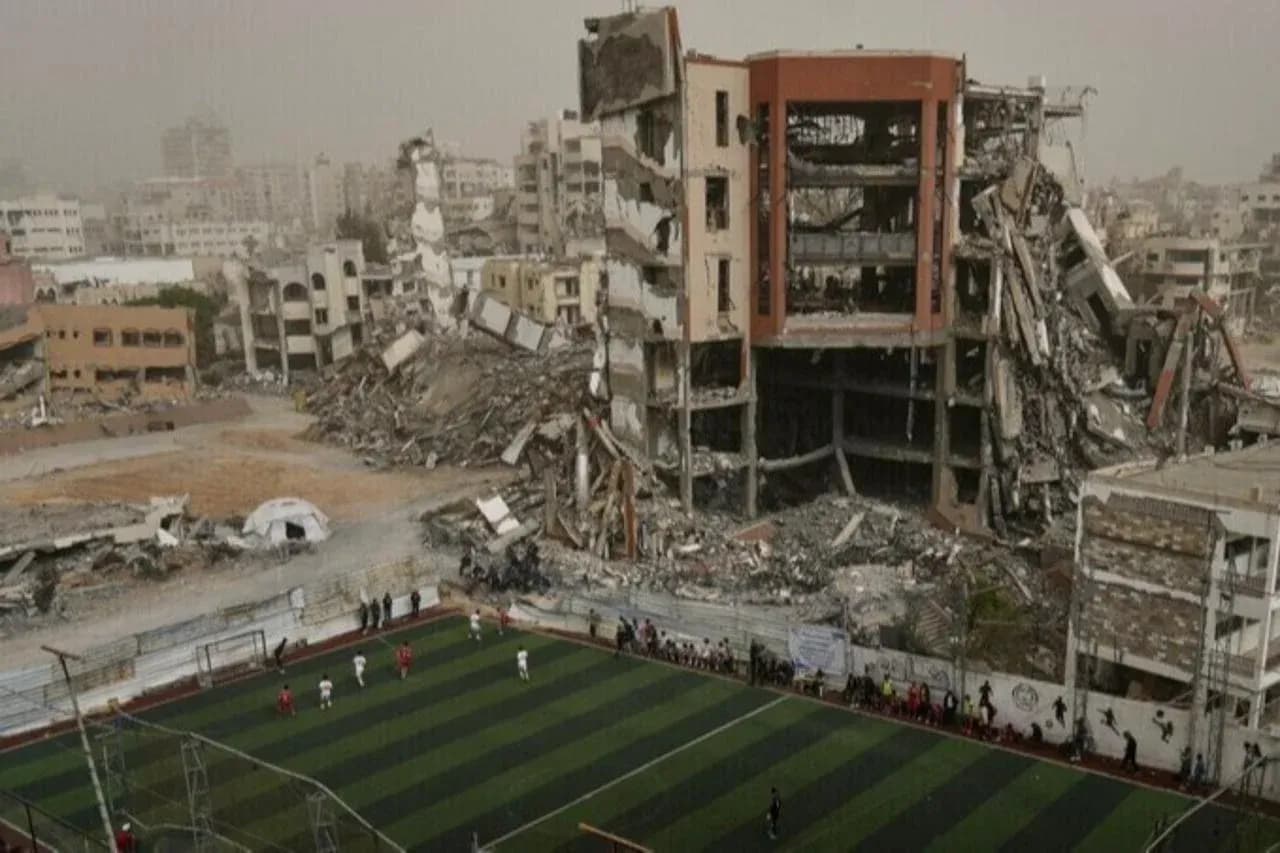 Football match in front of destroyed buildings Football match in front of destroyed buildings