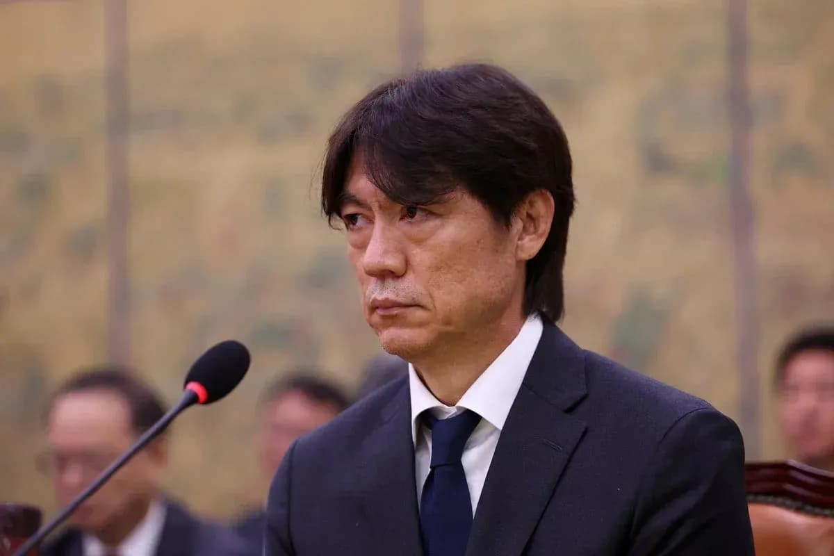 Man in suit speaking at press conference Man in suit speaking at press conference
