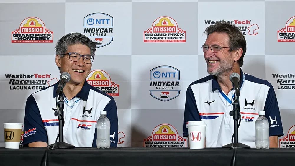 Two men at a press conference for IndyCar series Two men at a press conference for IndyCar series