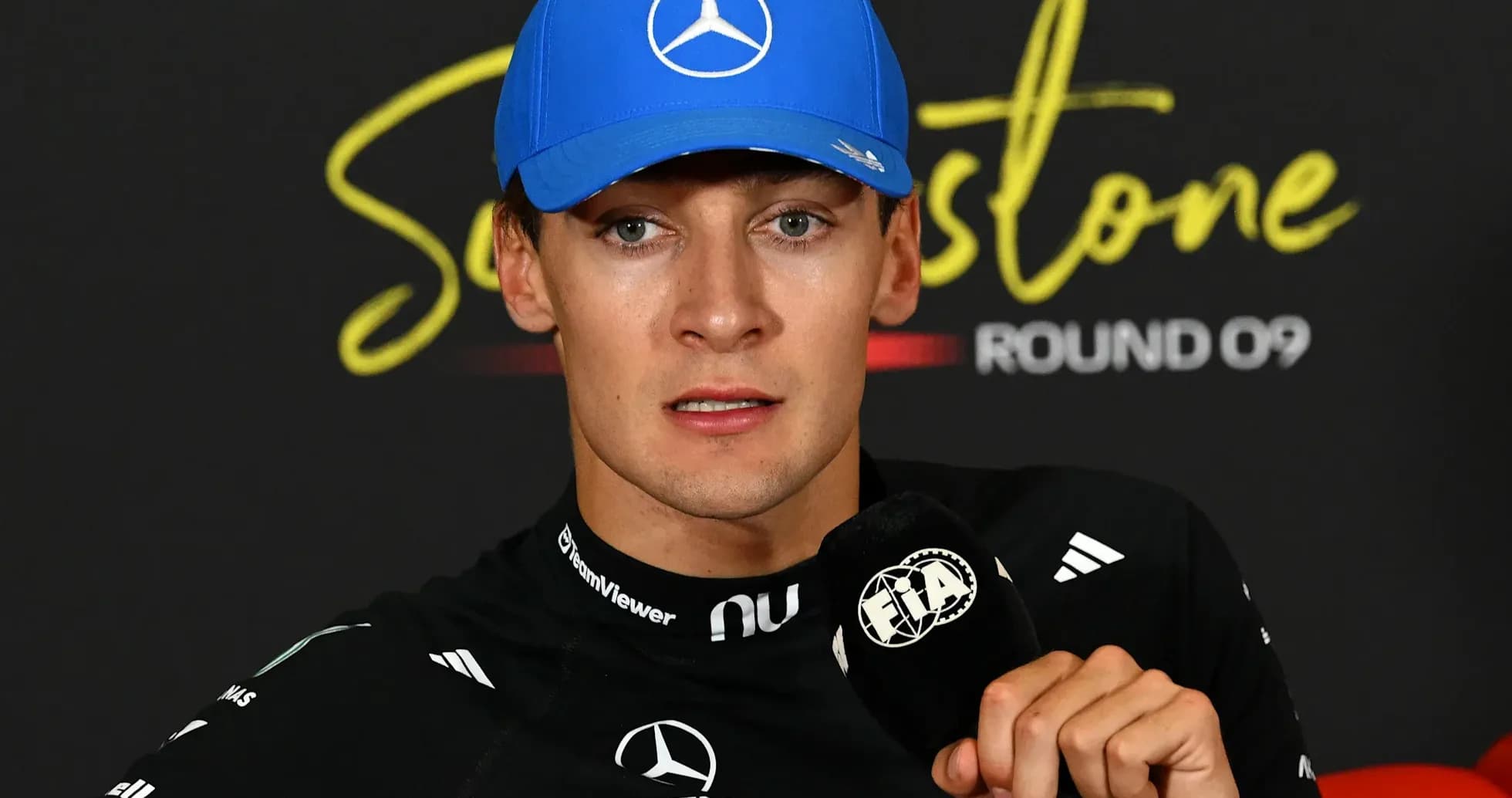 Formula 1 driver at press conference with microphone Formula 1 driver at press conference with microphone