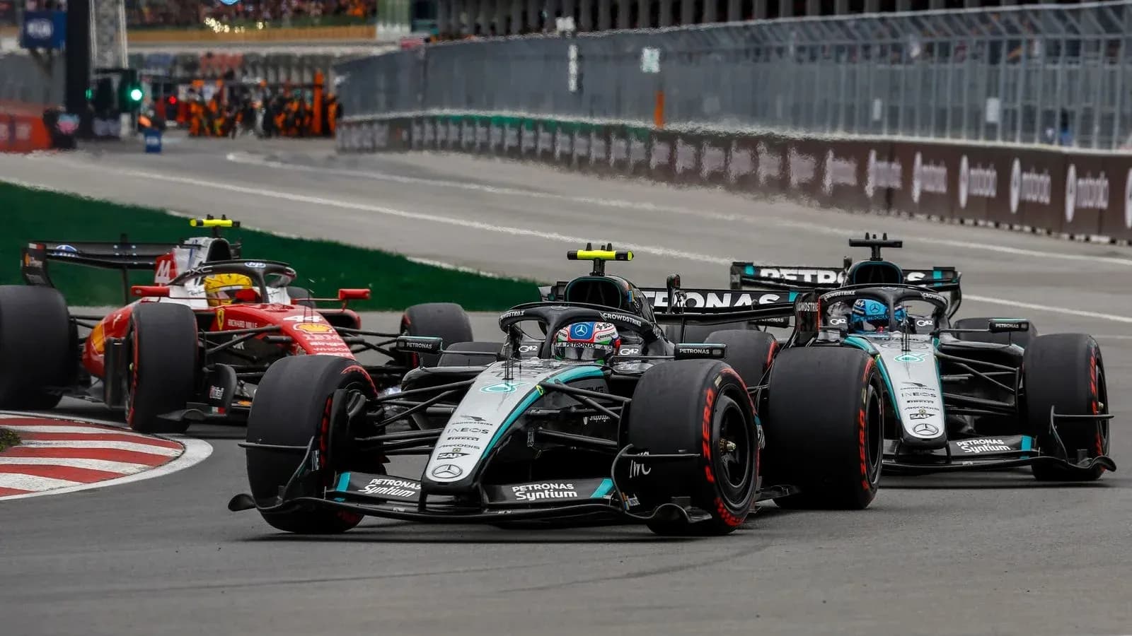 Mercedes and Ferrari cars racing closely on track Mercedes and Ferrari cars racing closely on track
