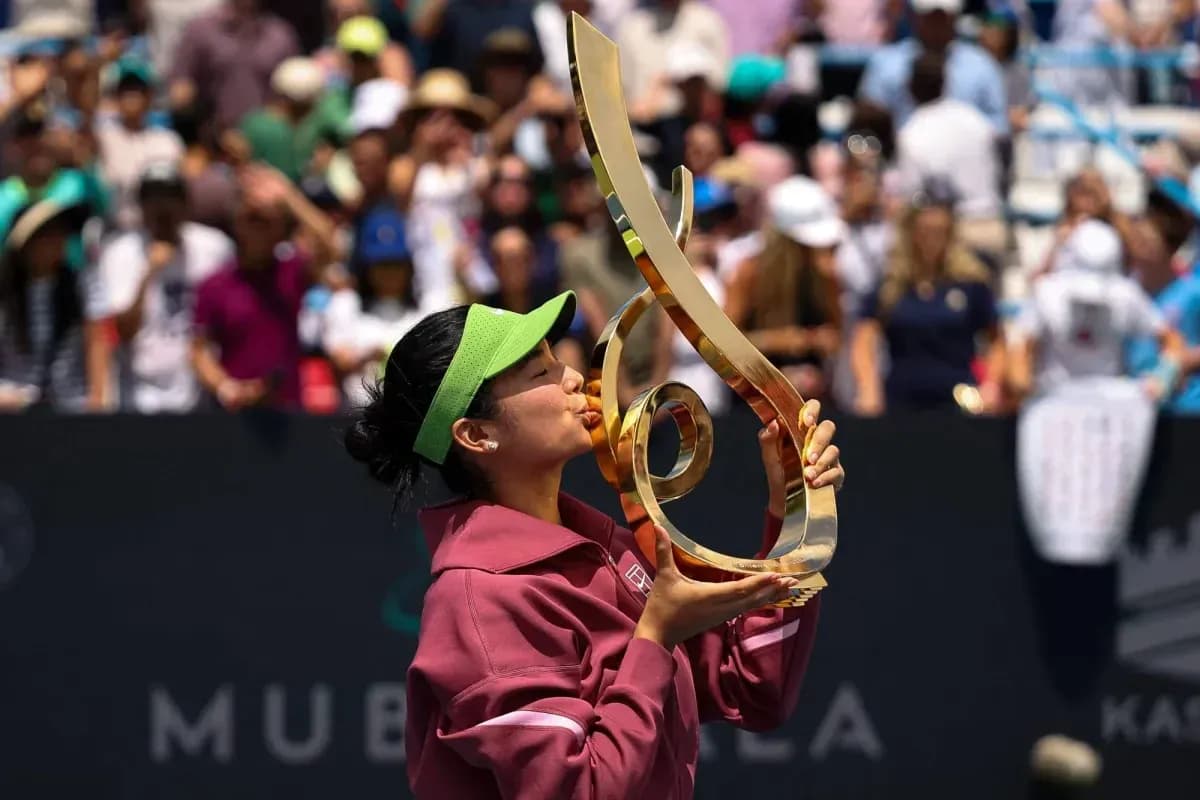 Tennis player kissing trophy after winning match Tennis player kissing trophy after winning match
