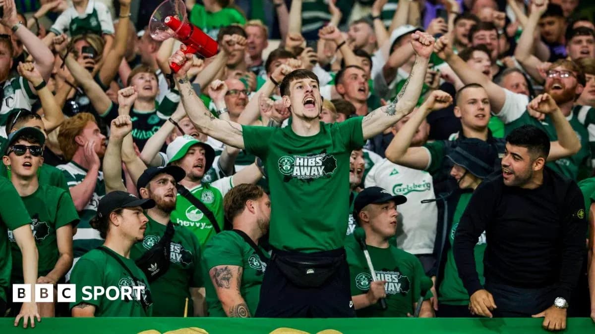 Fans cheering in green shirts at a match Fans cheering in green shirts at a match