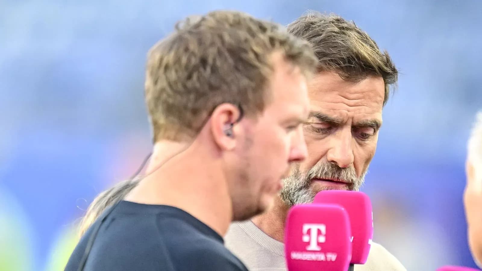 Duo interviewing on the field with microphones Duo interviewing on the field with microphones