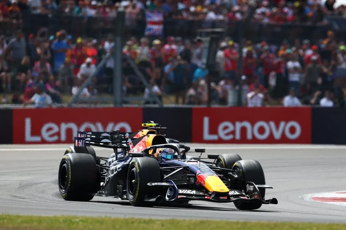 Formula 1 car racing during a sunny event Formula 1 car racing during a sunny event