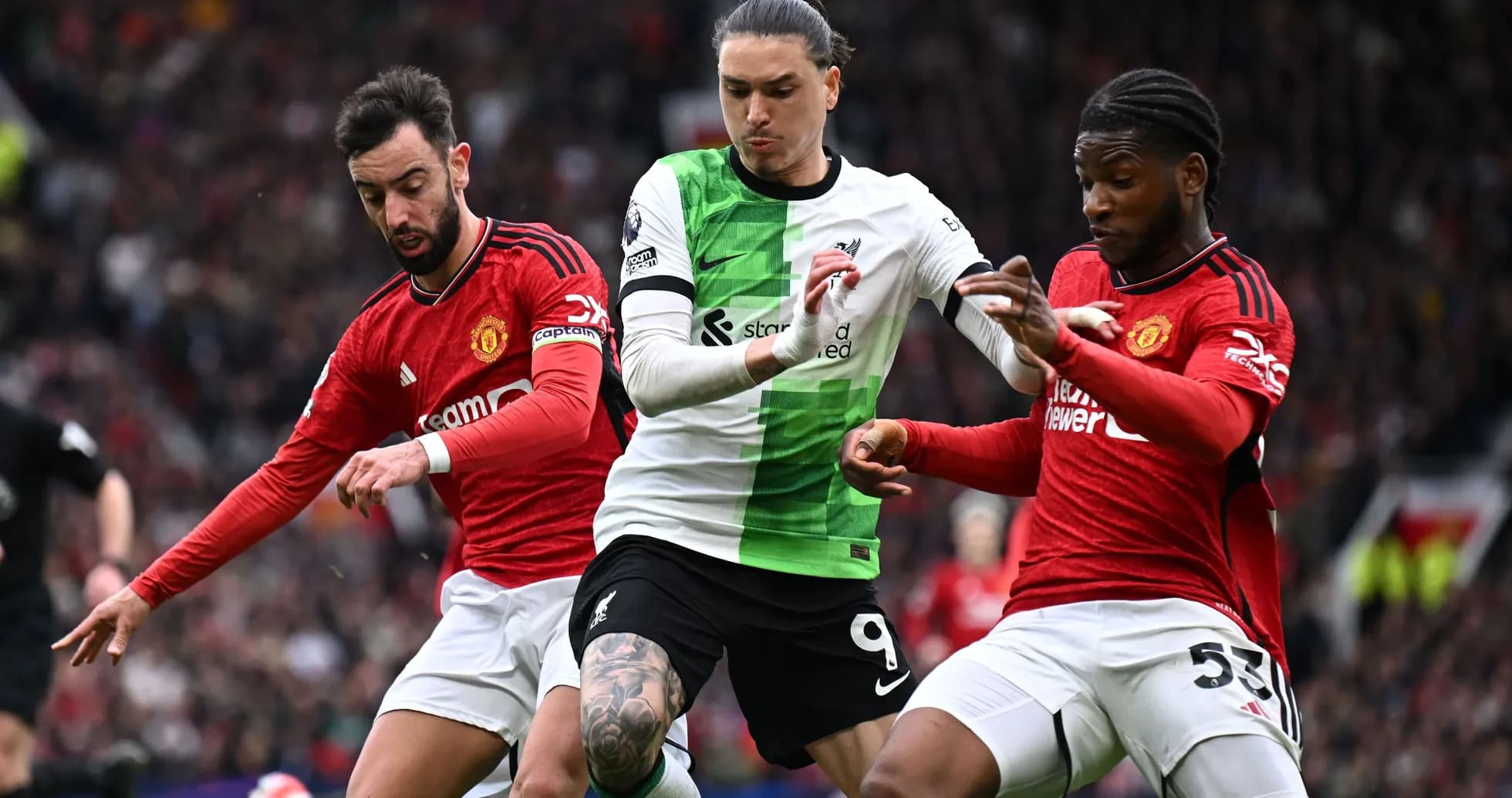 Liverpool and Manchester United players battling for possession Liverpool and Manchester United players battling for possession
