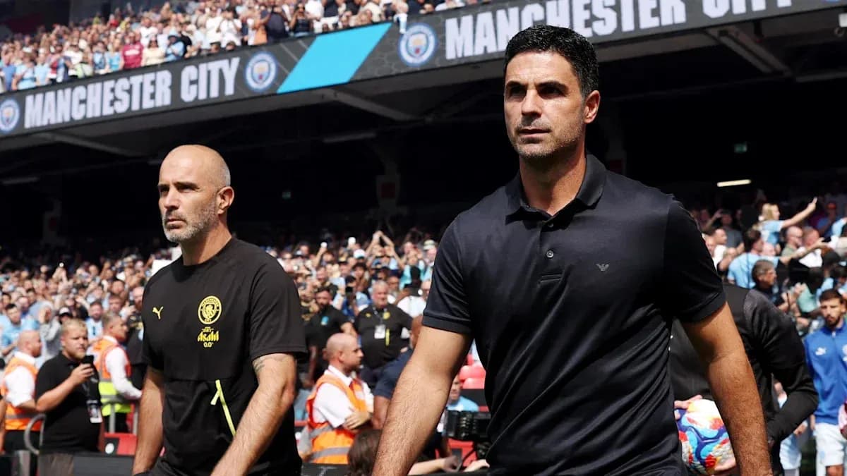 Two football managers walking onto the pitch Two football managers walking onto the pitch