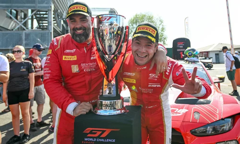 Two drivers celebrating with trophy after race Two drivers celebrating with trophy after race