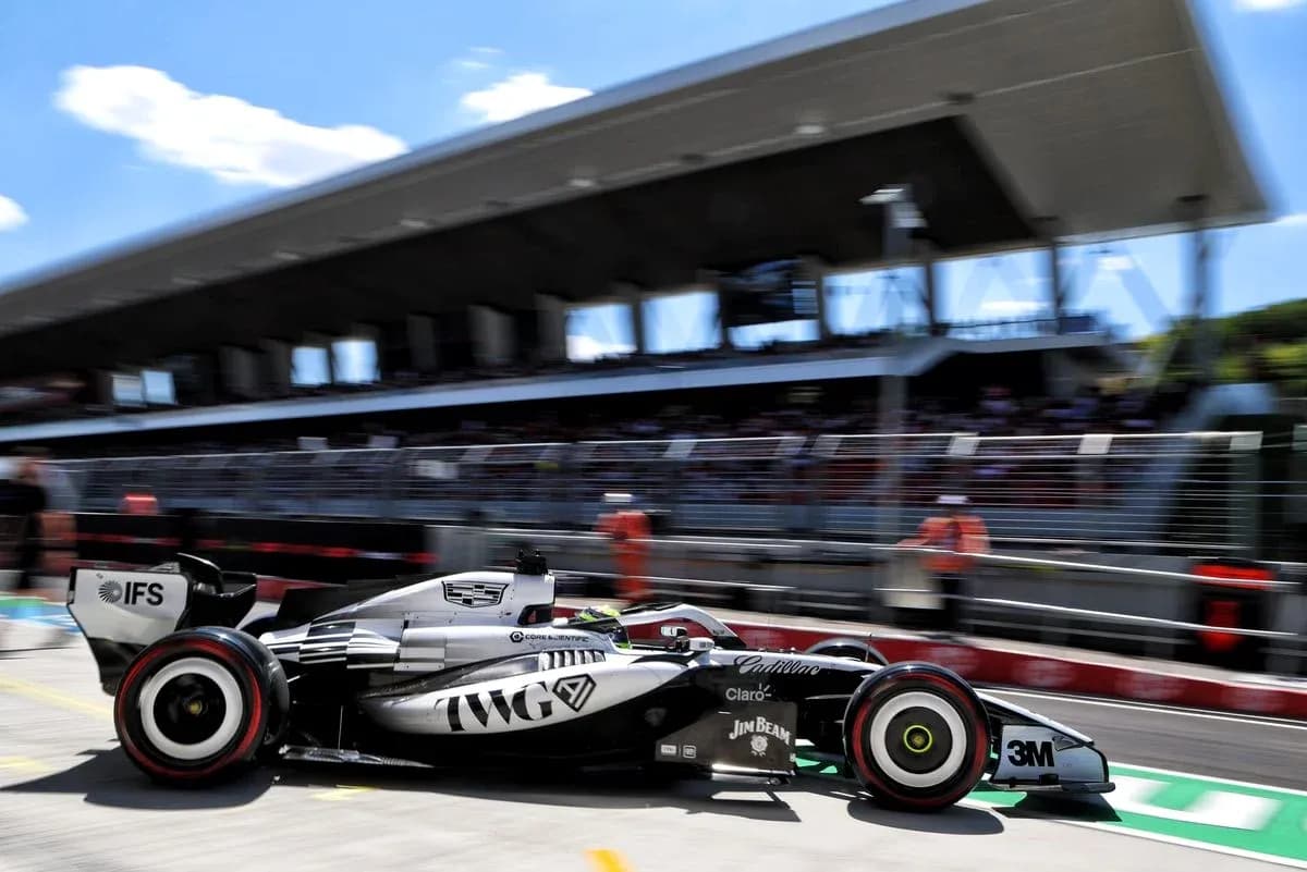 Formula 1 car speeding past pit lane Formula 1 car speeding past pit lane