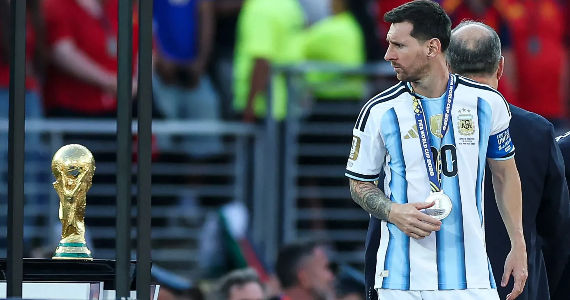 Lionel Messi walking past the World Cup trophy Lionel Messi walking past the World Cup trophy