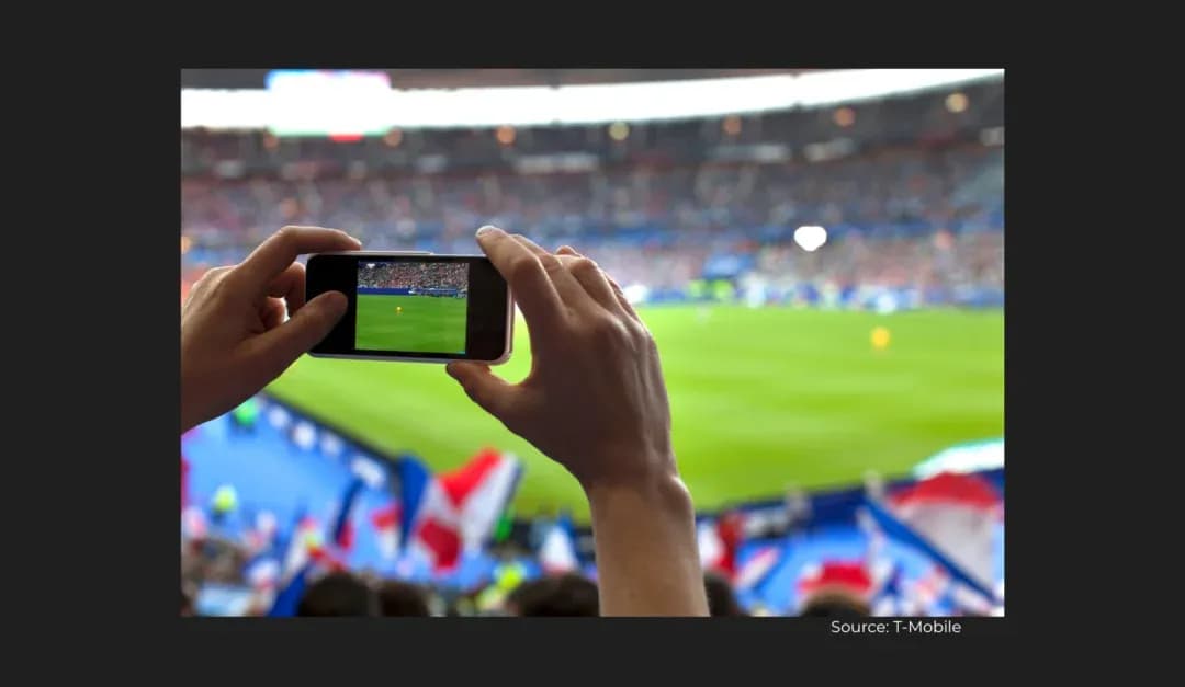 Fan recording football match on smartphone in stadium Fan recording football match on smartphone in stadium
