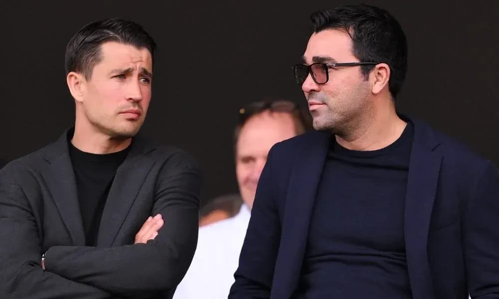 Two men discussing in a sporting event setting Two men discussing in a sporting event setting