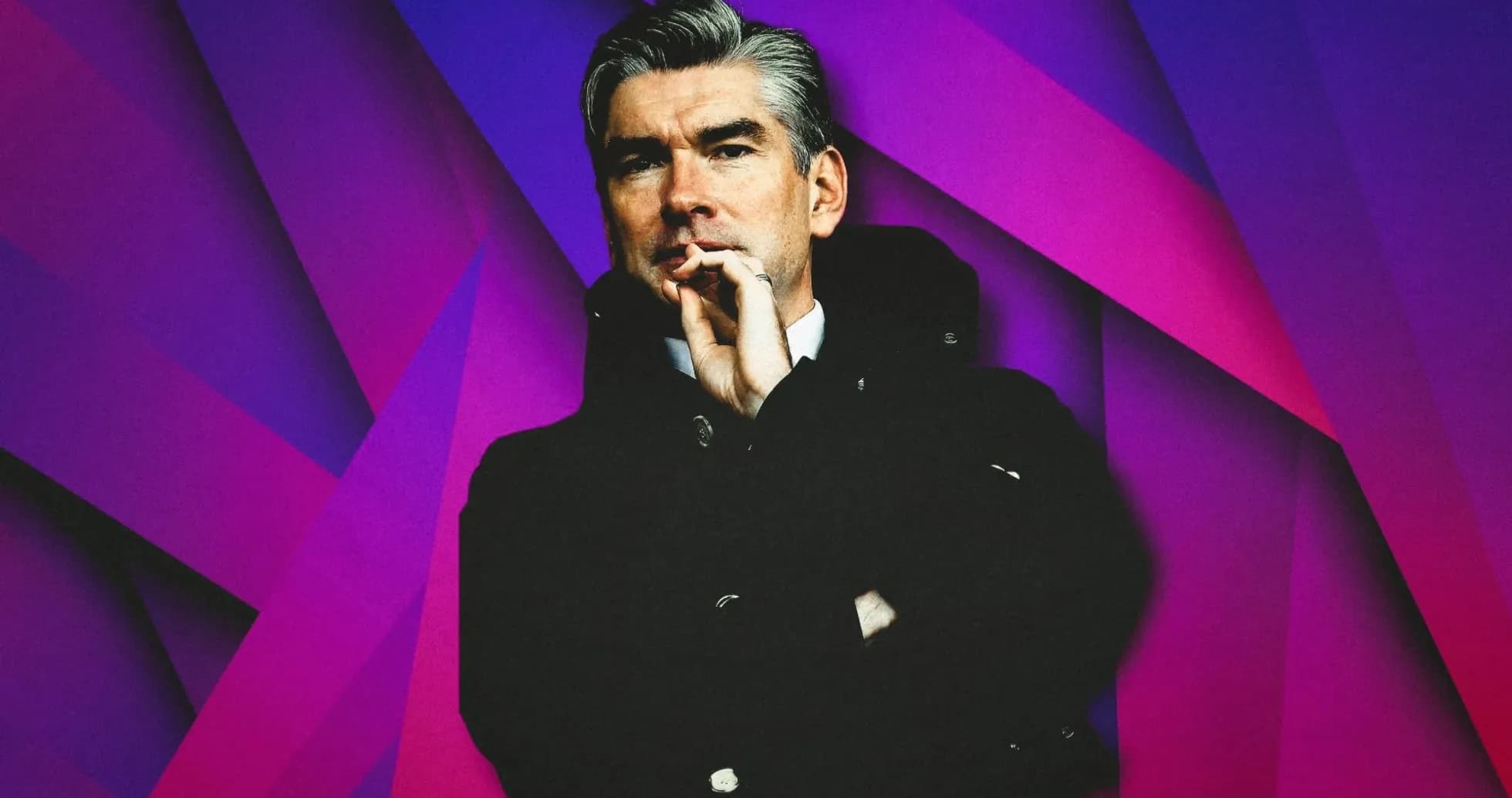 Coach in a dark coat against colorful background Coach in a dark coat against colorful background