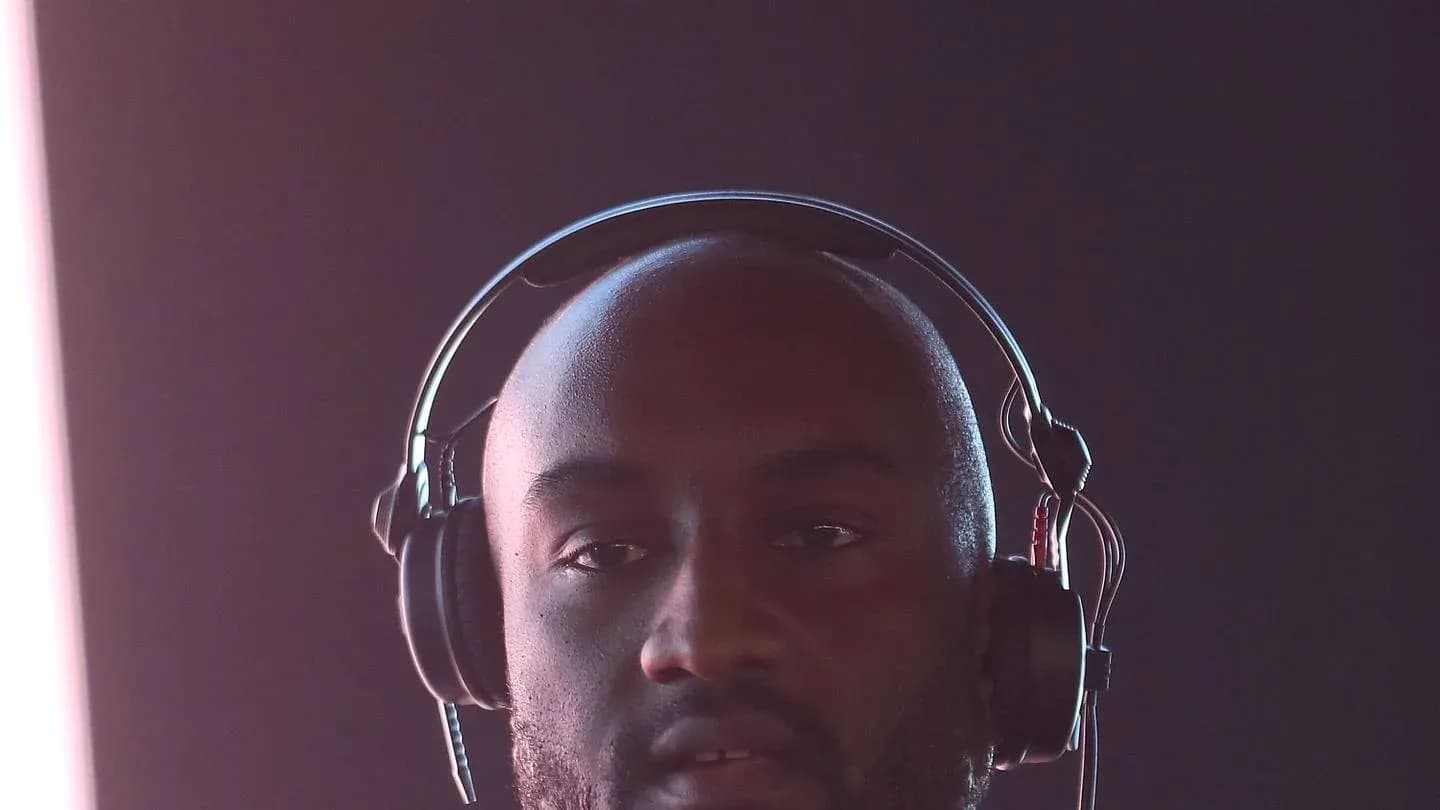 Man wearing headphones against a dark background Man wearing headphones against a dark background