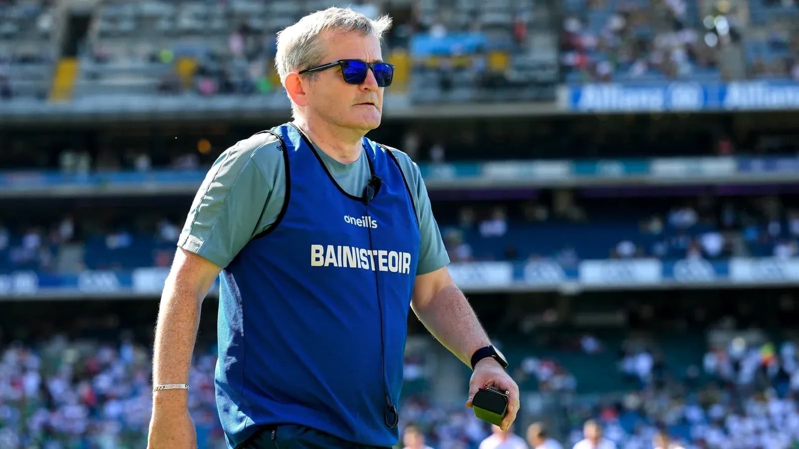 Coach wearing sunglasses on the field during match Coach wearing sunglasses on the field during match