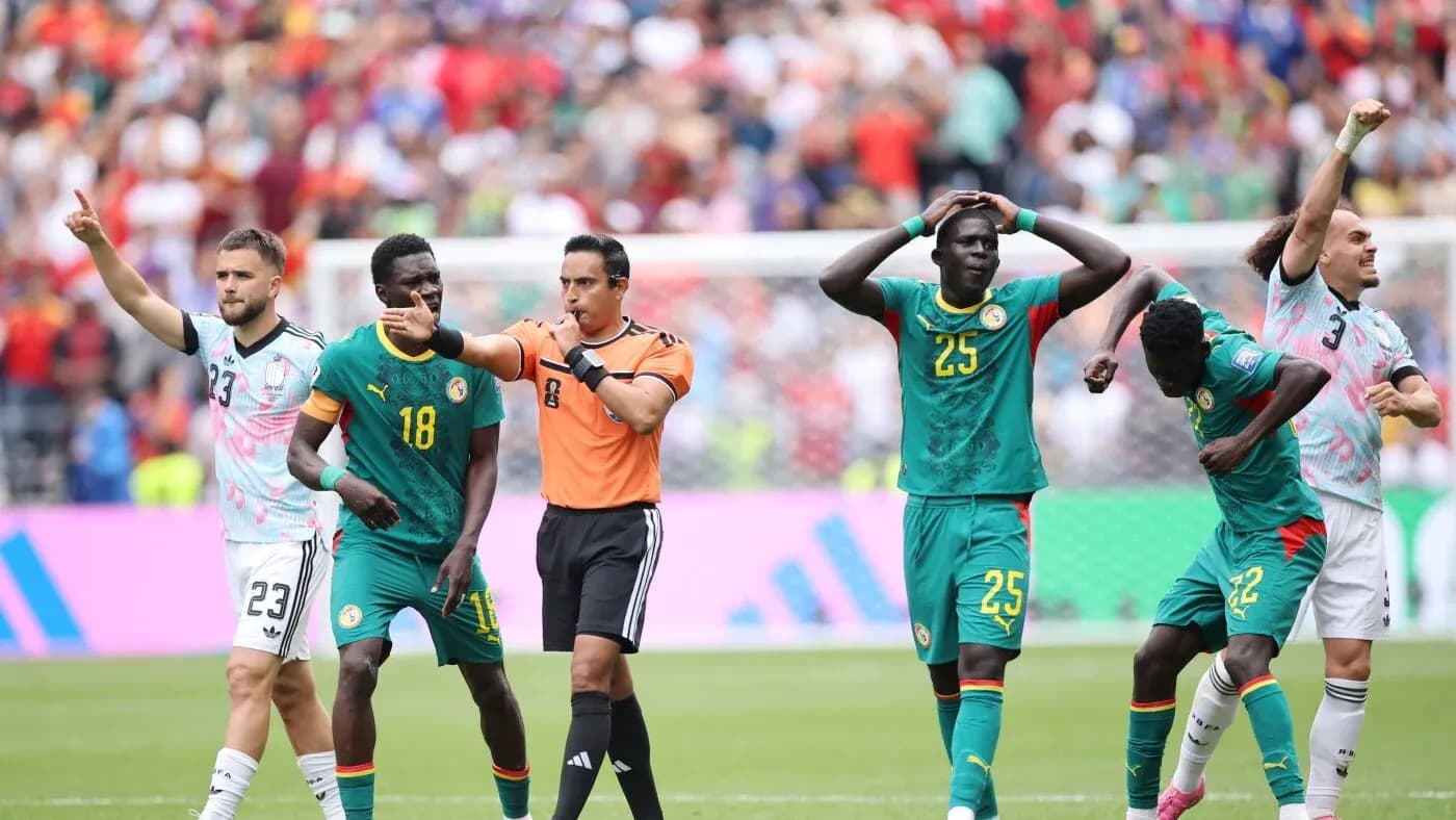 Referee issuing a decision during a match with players Referee issuing a decision during a match with players