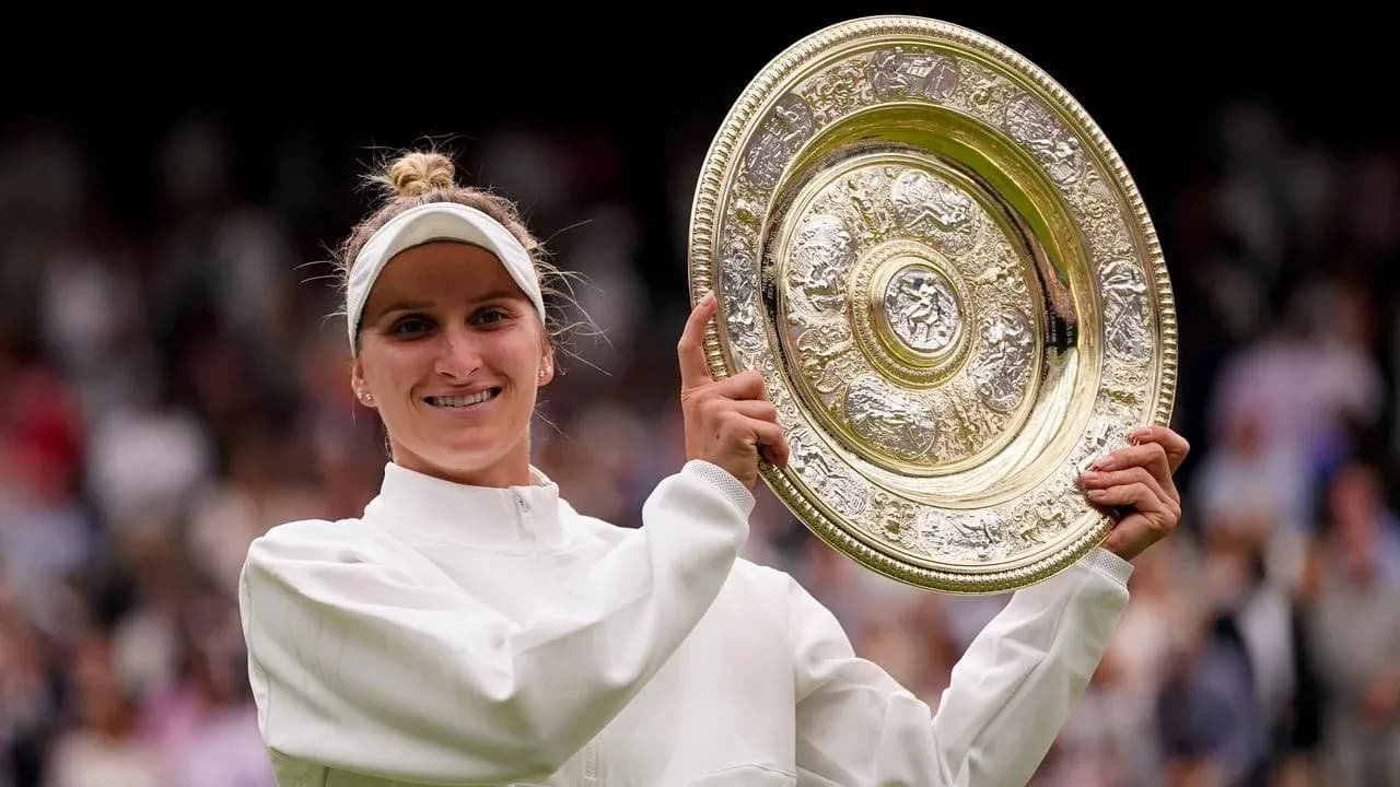 Tennis player holding Wimbledon trophy after victory Tennis player holding Wimbledon trophy after victory
