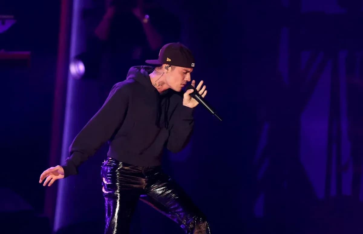 Artist performing on stage with microphone Artist performing on stage with microphone