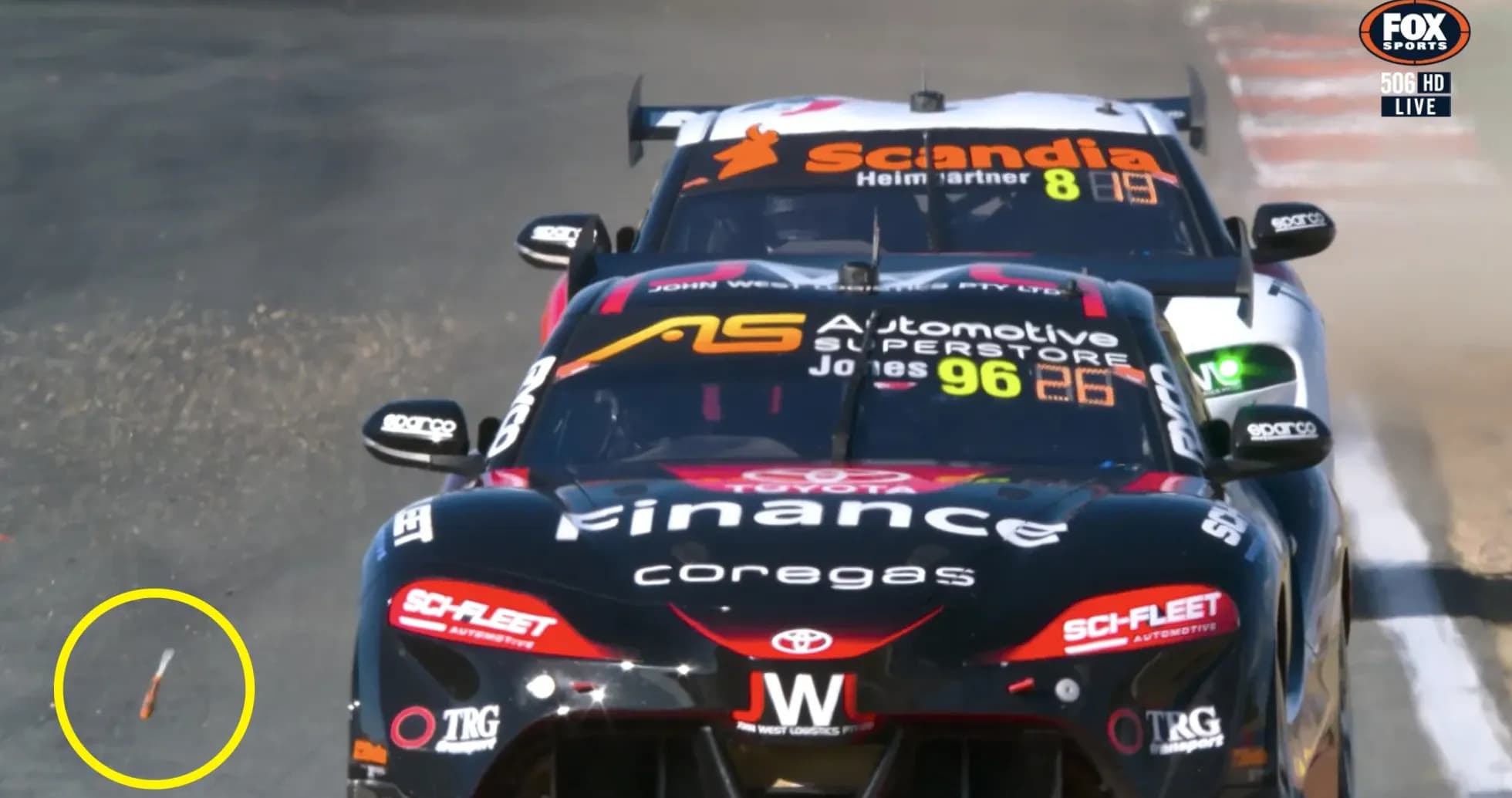 Two race cars competing on track with debris visible Two race cars competing on track with debris visible