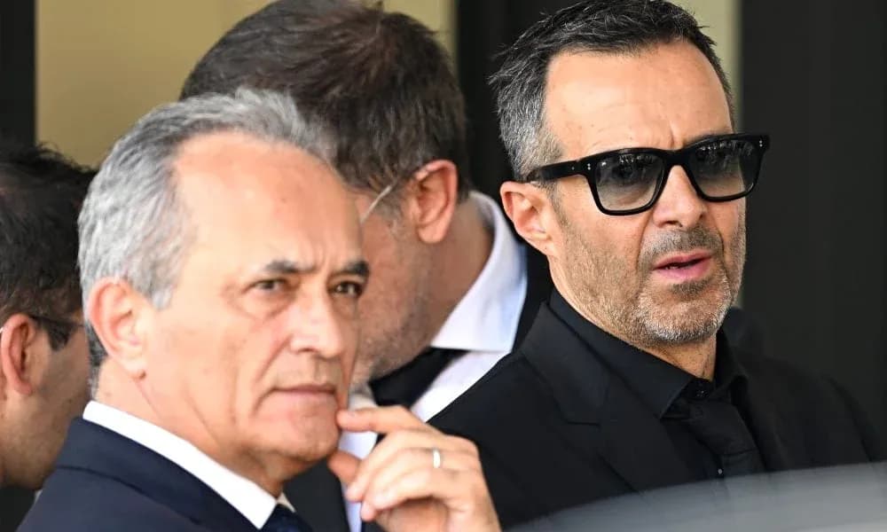 Two men in suits standing outdoors with sunglasses Two men in suits standing outdoors with sunglasses