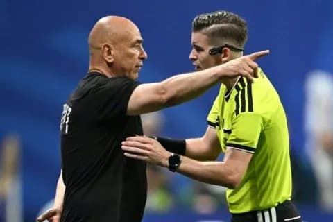 Referee discussing with coach during a match Referee discussing with coach during a match