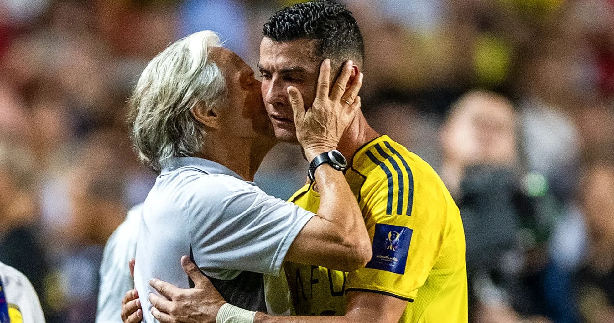 Coach embracing player during match moment Coach embracing player during match moment