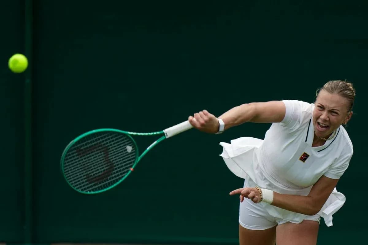Tennis player serving during match at Wimbledon Tennis player serving during match at Wimbledon