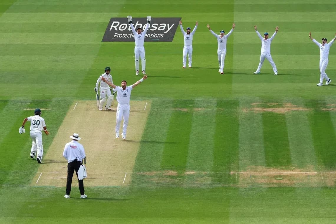 Bowler appealing as fielders celebrate wicket during match Bowler appealing as fielders celebrate wicket during match