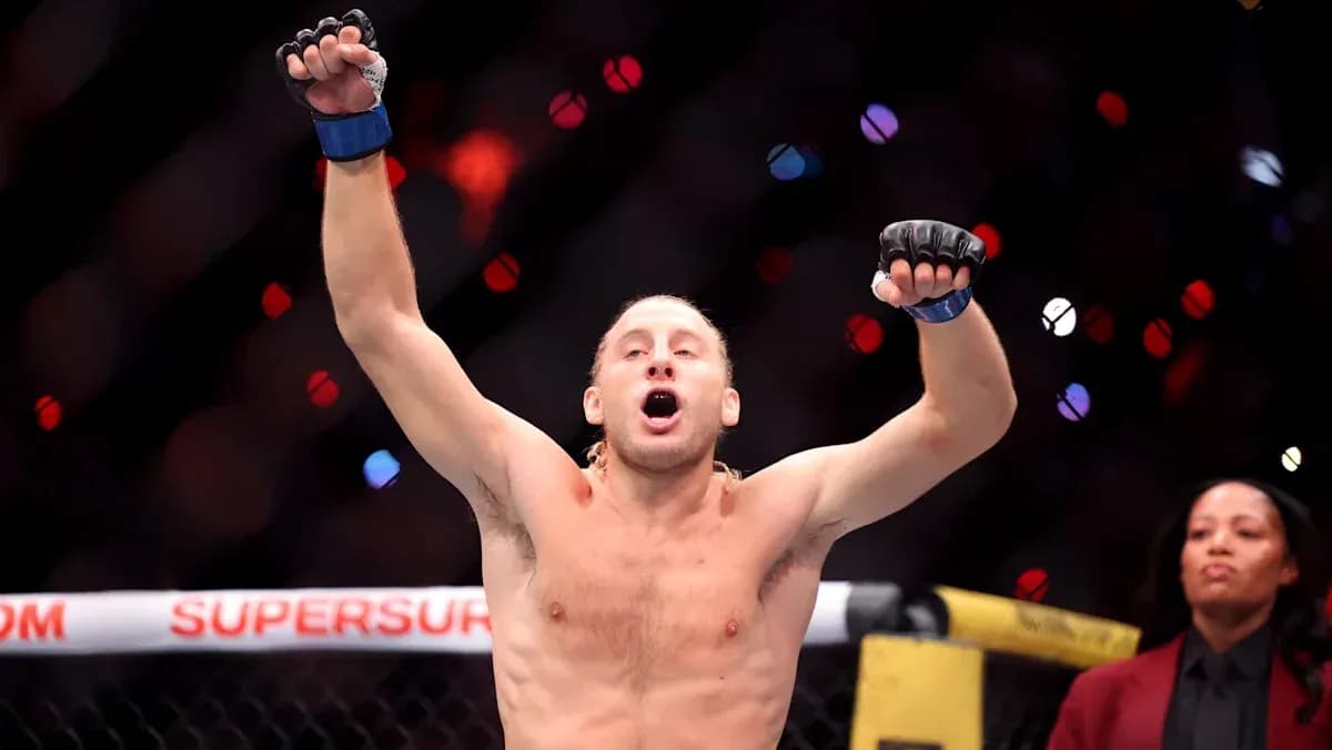 Fighter celebrating victory inside the octagon Fighter celebrating victory inside the octagon
