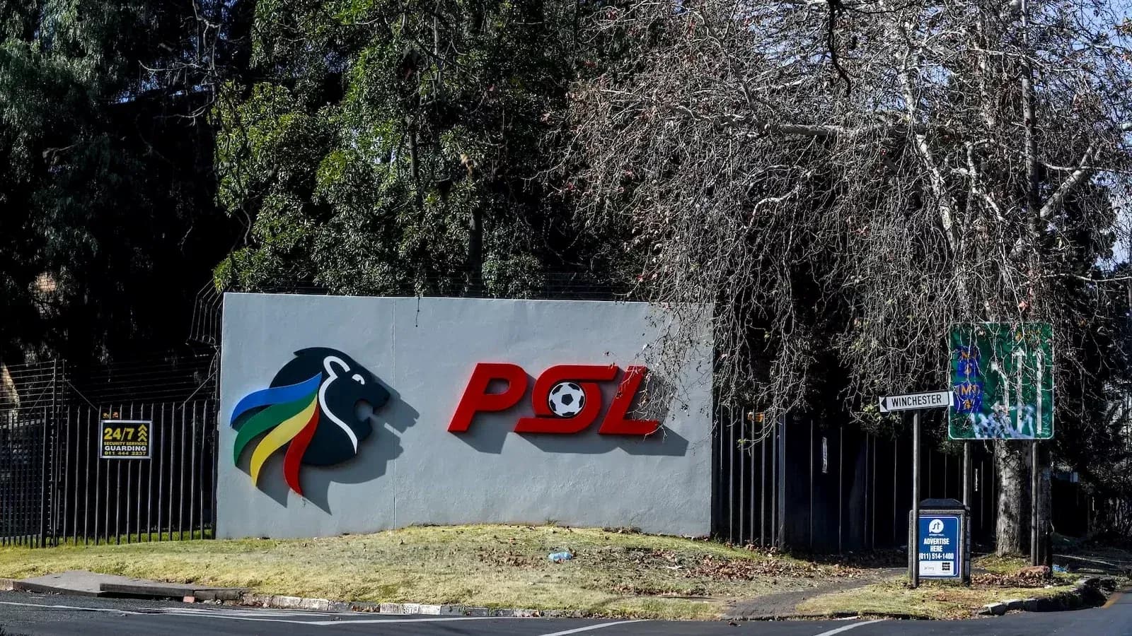 PSL logo on wall with surrounding trees PSL logo on wall with surrounding trees