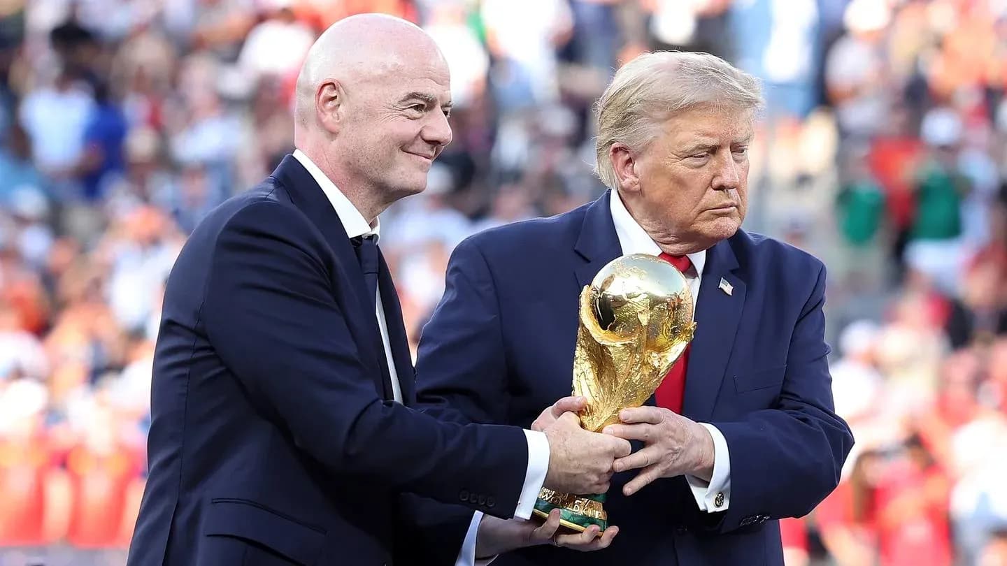 Gianni Infantino and Donald Trump holding World Cup trophy Gianni Infantino and Donald Trump holding World Cup trophy