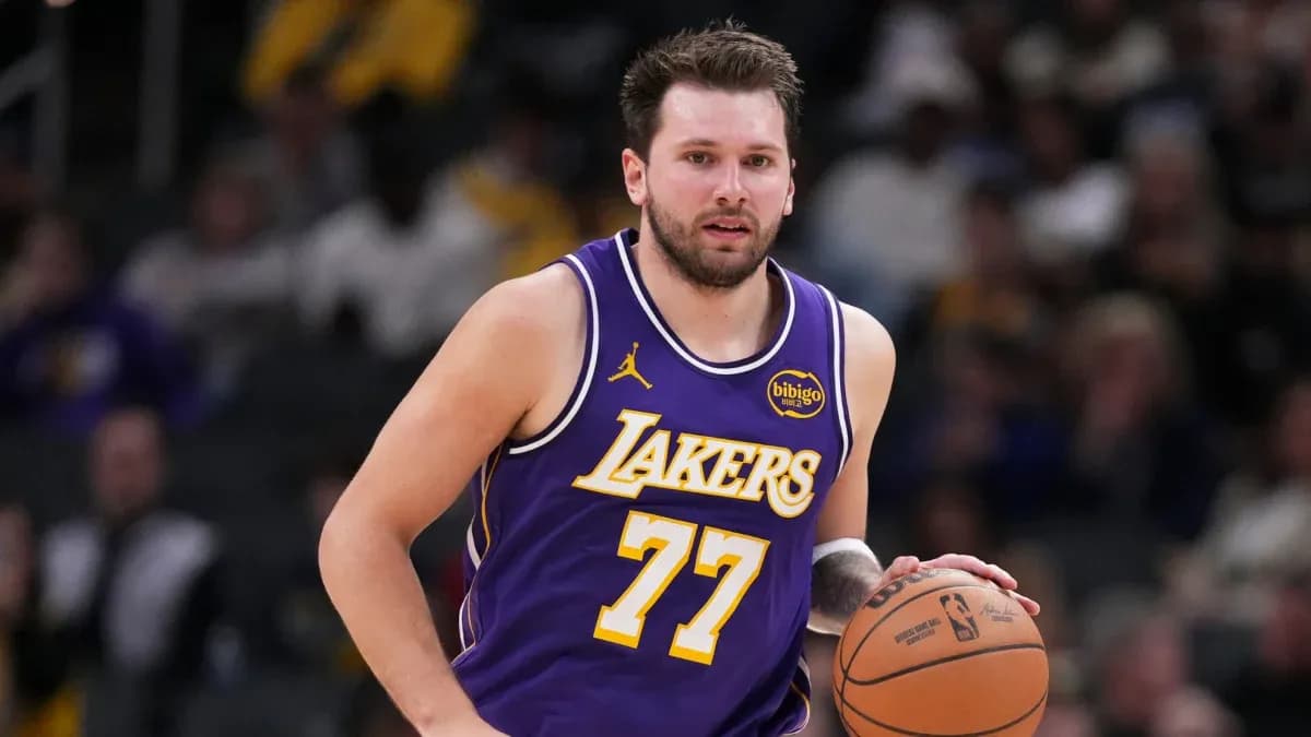Lakers player dribbling basketball during game Lakers player dribbling basketball during game