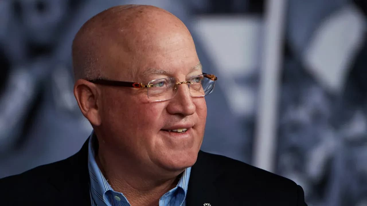 Man with glasses smiling during event Man with glasses smiling during event