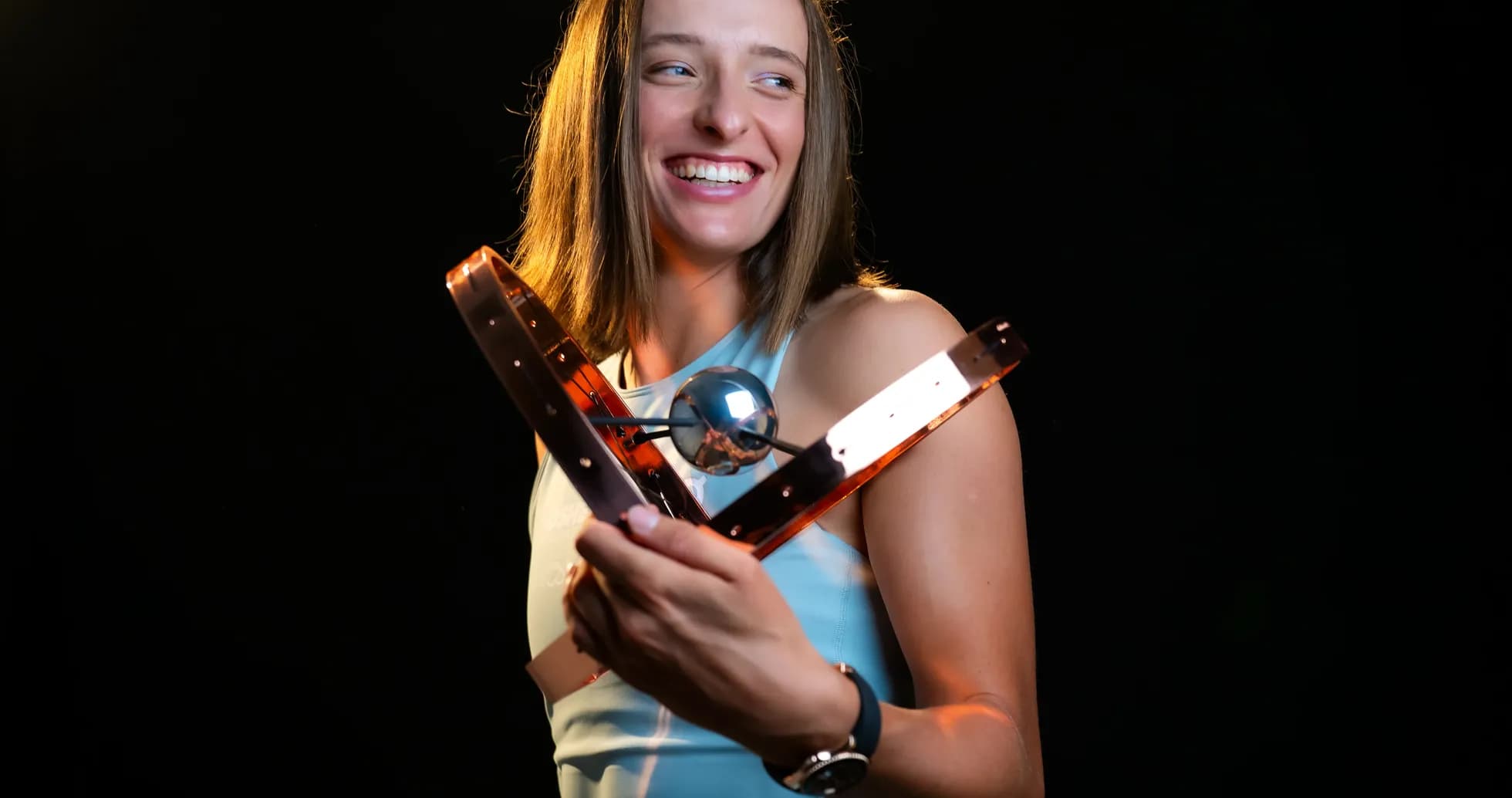 Athlete holding a trophy with a smile Athlete holding a trophy with a smile